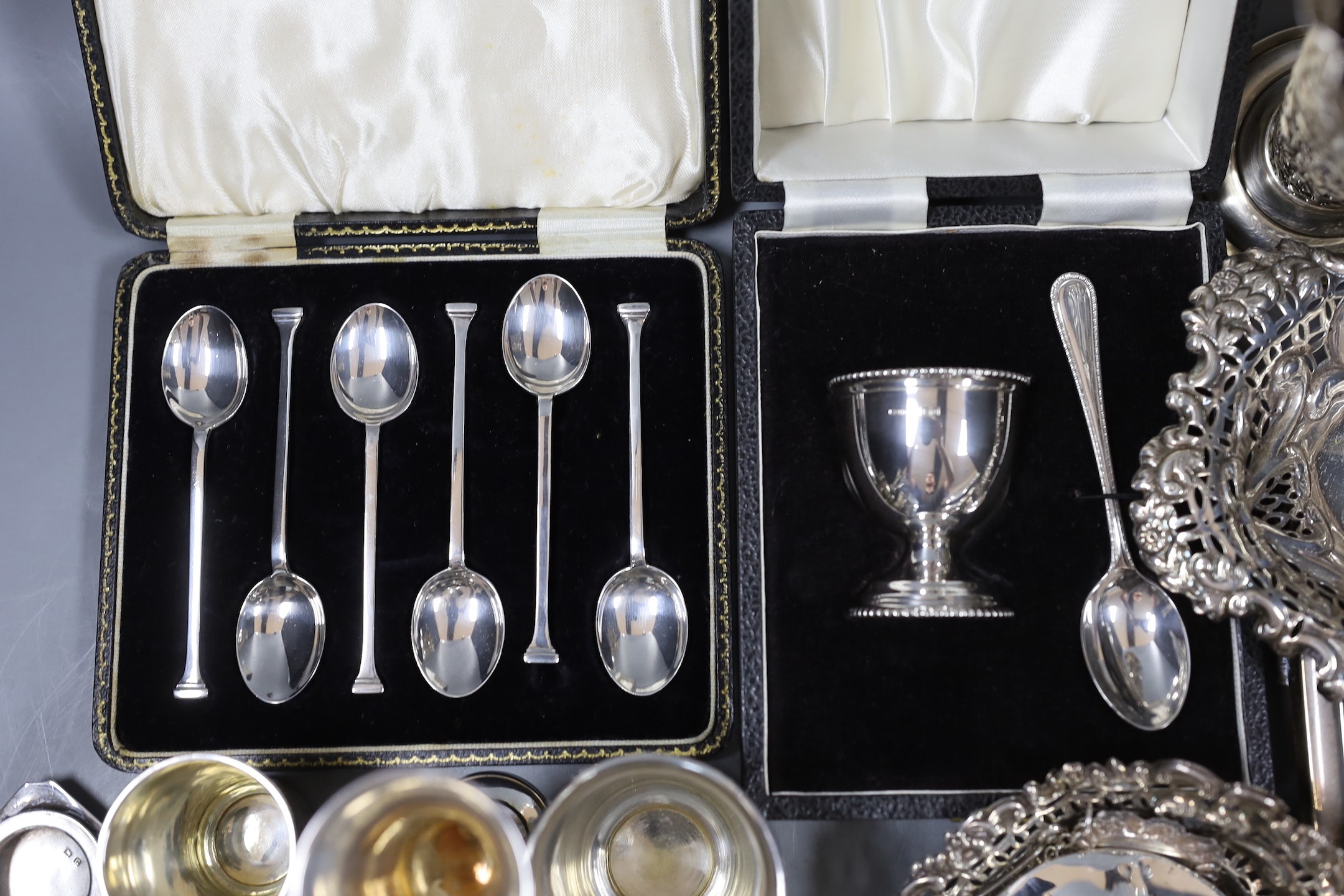 Assorted silver items including an Edwardian inkstand, Birmingham, 1902, 20.5cm, two silver bonbon dishes, cased teaspoons, cased christening duo, cased napkin rings, pair of pierced silver serving spoons, three napkin r